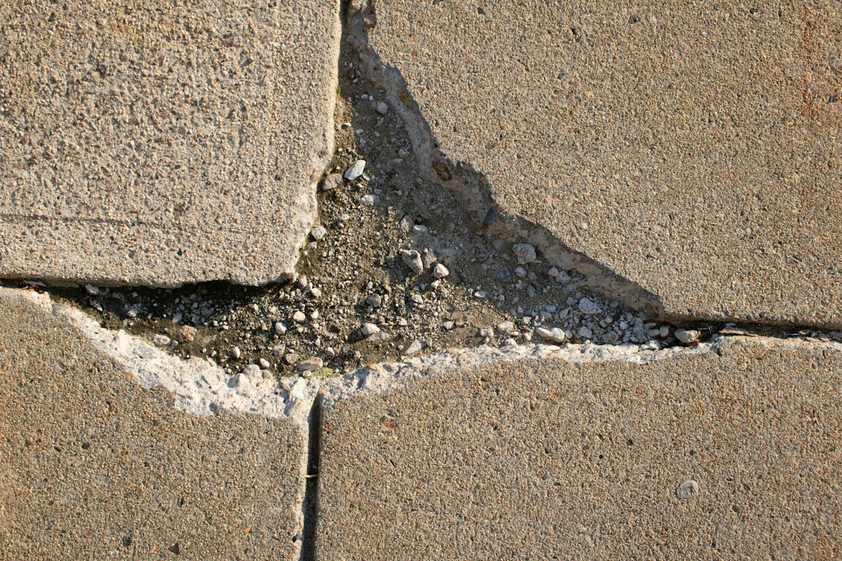 Long crack running across a concrete sidewalk